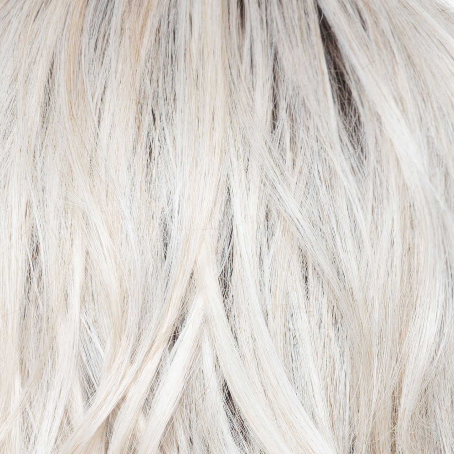 White Rose Blond-R - A white blond base with subtle warm brown highlights. The medium-brown root creates a vibrant appearance.